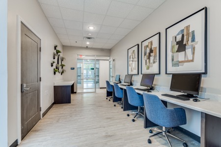 Business center with computers and seating at The Citizen