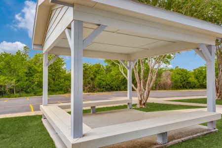 Covered outdoor pavilion with bench seating at The Citizen